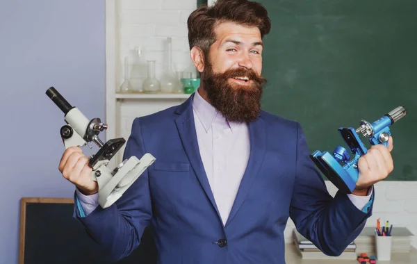 Funny bearded teacher, student hold microscope. Positive human emotions facial expressions