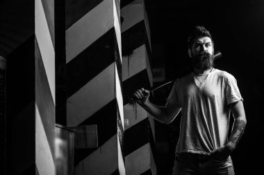 Power and strength. Attack concept. Angry man in T-shirt ready to swing. Sport. Threatening angry man with a beard. Strong temper