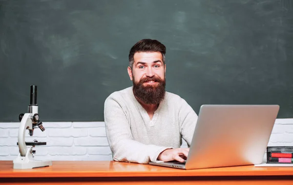 Bearded tutor near chalkboard. Student Studying Hard Exam. Teachers day. Tutor. Science and education concept. School day. Education