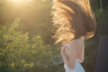 Sexy nude woman with beautiful movement hair. Naked sensual girl with bare shoulders. Spring romantic woman, glamour sensual young stylish lady