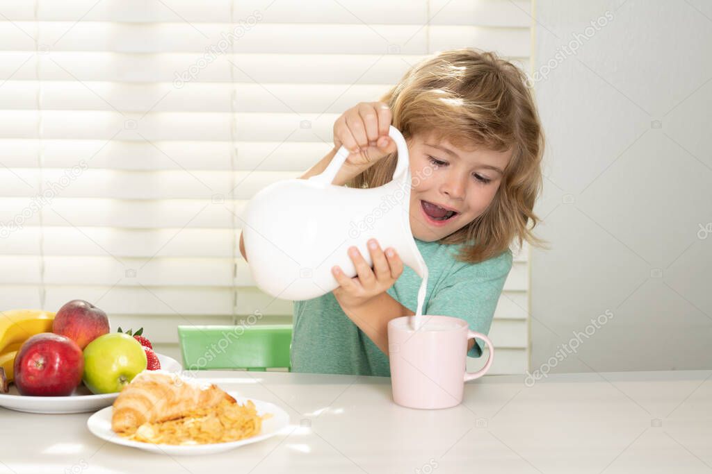 Kid bot eating meal. Healthy nutrition for children. Child enjoy eating for breakfast or dinner with appetite. Fuuny little boy pouring whole cows milk for breakfast