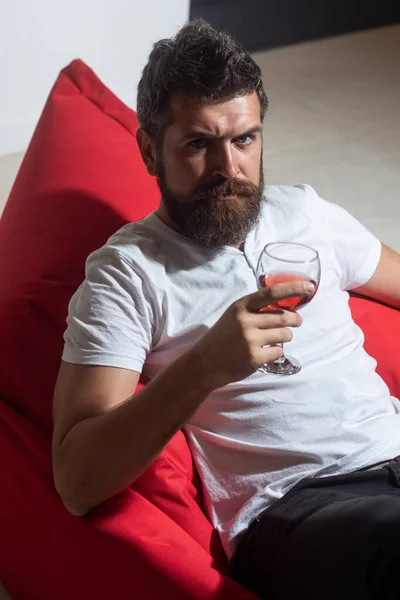Celebrate alone. Bearded man with wine. Home alone party. Hipster with alcohol
