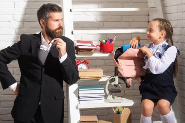 Dad primary pupil kid daughter preparing school homework. Studying homeschooling with father. Children education, home schooling concept