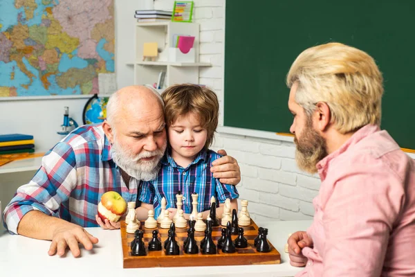 Fathers day. Grandfather father and son, men generation. Three different generations ages grandfather father and child son playing chess