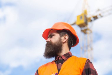 Portrait of worker man at construction site. Building and construction site concept