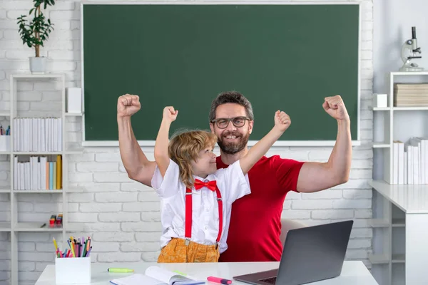 Excited school teacher with a schoolboy. Teacher and students from elementary school in the classroom