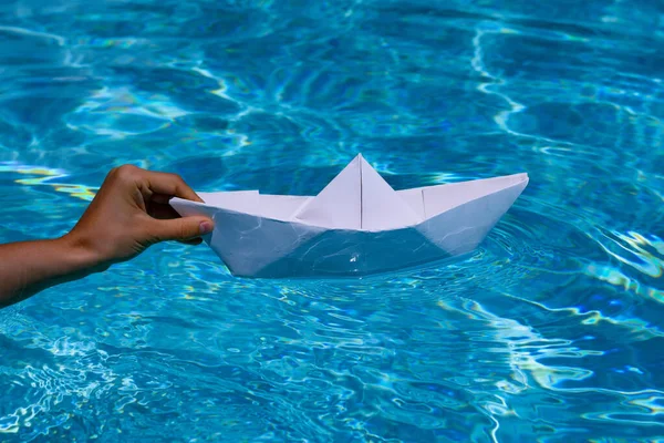 Paper ship in hand. Hand and paper boat. Origami paper boat