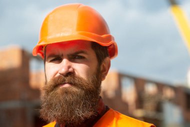 Construction worker in uniform and safety equipment have job on building. Industrial theme
