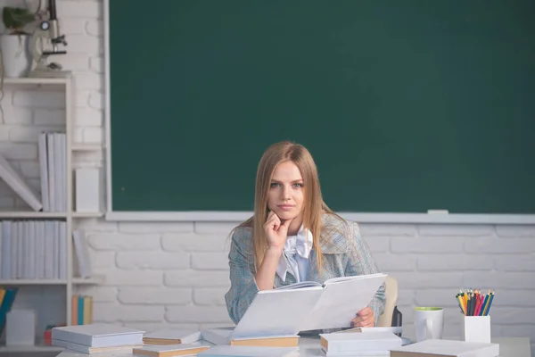 High school student learning english, reading book or mathematics in class