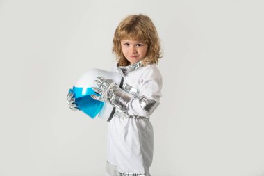 Small child wants to fly an in space holding astronaut helmet. Copy space