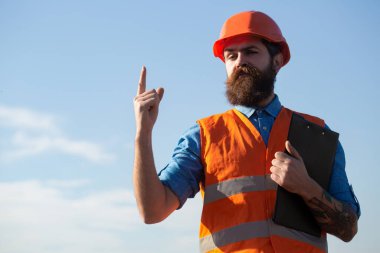 Construction worker in uniform and safety equipment have job on building. Improvement and renovation. Brutal man builder. Engineer builder in uniform