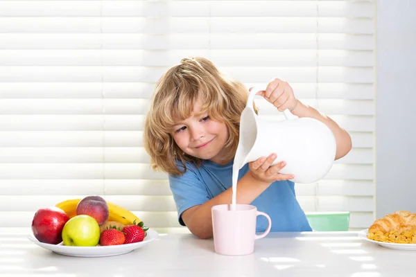 Kid boy pouring whole cows milk. Portrait of preteen child eat fresh healthy food in kitchen at home. Kid boy eating breakfast before school. Vitamin and nutrition protein for kids