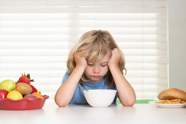 Portrait of child with no appetite. Concept of loss of appetite. Kid bot eating meal. Healthy nutrition for children. Child enjoy eating for breakfast or dinner with appetite