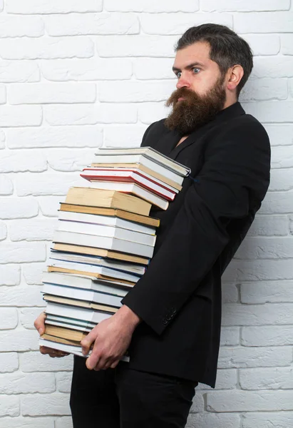 Funny teacher or professor with book stack. Thinking serious mature teacher. Falling books concept. Mature professor near educational books for exams at the university. Teachers day