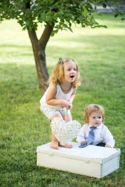 Çayır tarlasında küçük şirin bir bebek. Bebek dışarıda yürüyor, aile tatilleri, yaz mevsimi doğası. Korsanlı çocuklar