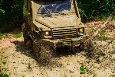 Off-road yarışında çamur ve su sıçraması. En iyi off road araçları. Büyük 4x4 arabalı seyahat konsepti. Çamurda iz sürmek. 4x4 off-road SUV arabası. Offroad vagonu. Safari. Yol macerası. Macera seyahati
