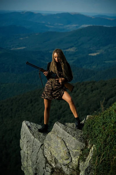 Hunting - women hobby. Hunting Gear and Hunting Clothing Equipment for hunter. Woman hunter with a gun