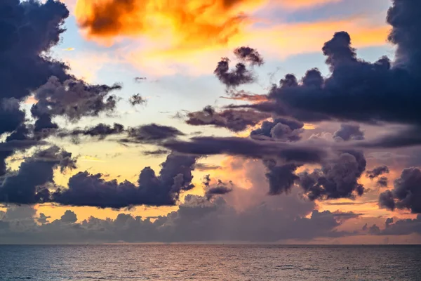 Sunset on sea background. Nature wallpaper with summer sea. Water sea texture. Calm sunrise on tropical sea. Clouds and waves on ocean dusk, twilight