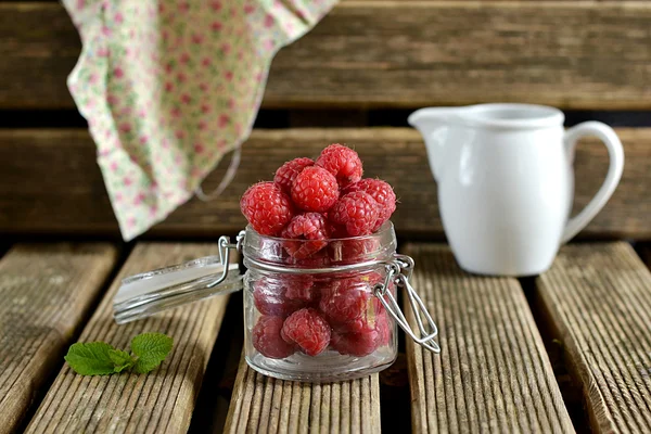 Raspberries in a jug with mint — Stock Photo, Image