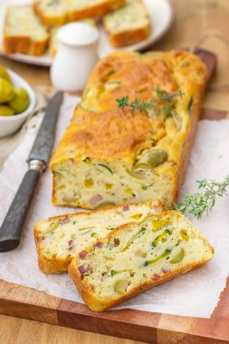 French savoury cake with olives, zucchini, ham, sweet pepper and cheese clipart
