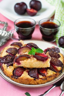 Sweet plum cake with cinnamon served with mint leaves