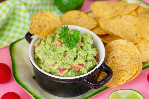 Traditional Mexican avocado salad dip Guacamole served with tortilla chips