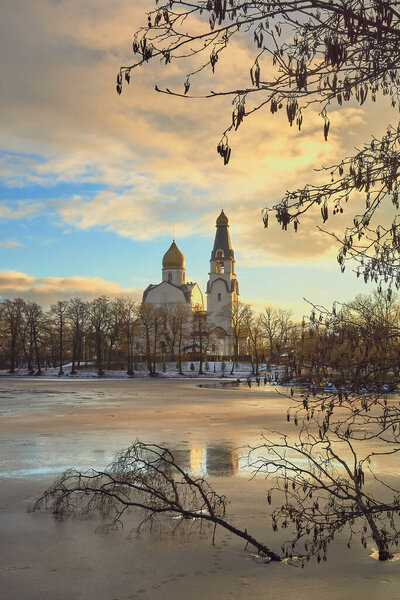 Thaw in December: winter Sestroretsk, warm clouds, church.
