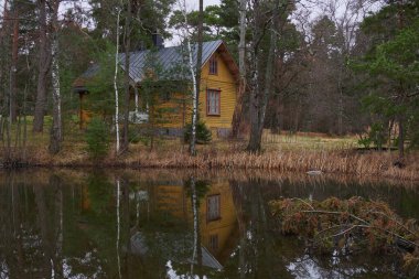 Seurasaari Island in Finnish Helsinki: autumn, yellow house near pond.
