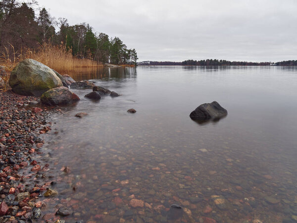 Seurasaari Island in Finnish Helsinki: autumn, picturesque coastline with clear water.