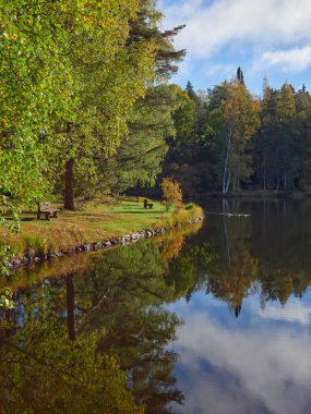 Finlandiya 'nın Hameenlinna kentindeki Aulanko doğa koruma ve dinlenme bölgesinde sonbahar, renkli ağaçlar, yansıma.