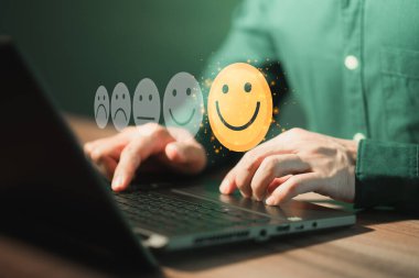 Man using a laptop in give rating to service experience on application. Online customer review satisfaction feedback survey.