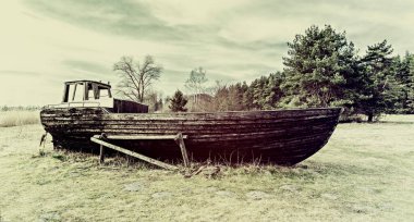 Old fishing boat anchored on a beach of the Baltic Sea