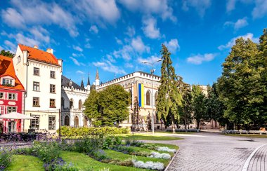 Flowered Livu square in the center of old Riga with numerous coffee shops and restaurants, Latvia. Riga is the capital and largest city of Latvia, a major commercial, cultural, historical and financial center of the Baltic region