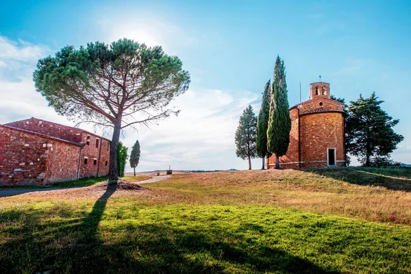 Magic landscape with chapel of Madonna di Vitaleta on a sunny day in San Quirico d'Orcia (Val d'Orcia) in Tuscany, Italy. Excellent tourist places.