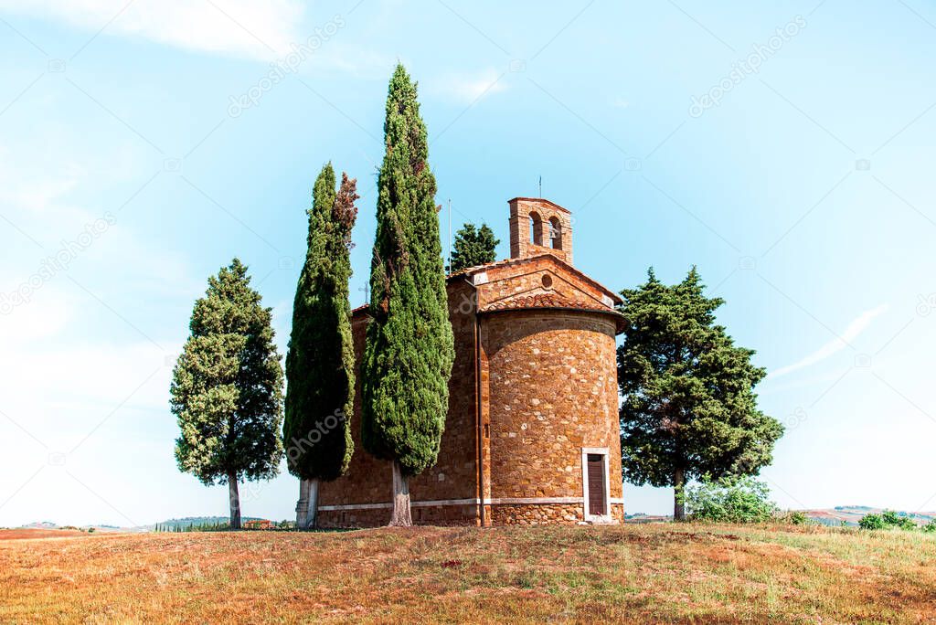 Magic landscape with chapel of Madonna di Vitaleta on a sunny day in San Quirico d'Orcia (Val d'Orcia) in Tuscany, Italy. Excellent tourist places.