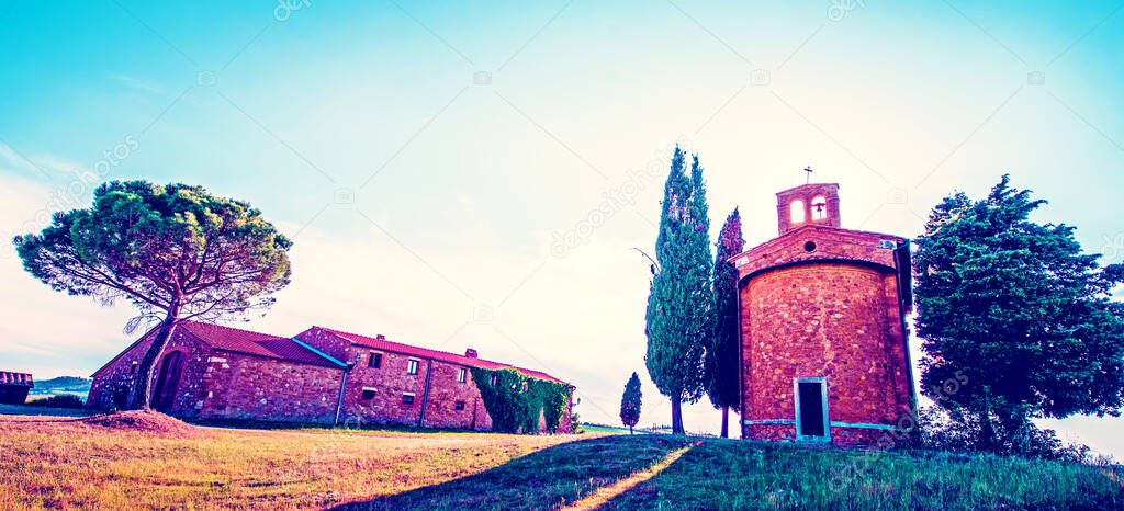 Tuscany, Italy, May, 2017: Magic landscape with chapel of Madonna di Vitaleta on a sunny day in San Quirico d'Orcia (Val d'Orcia) in Tuscany, Italy. Excellent tourist places.