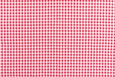 Kırmızı ve beyaz kareli kumaş desenli arka plan. Üst görünüm, düz pamuk kareli.