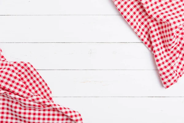 Top view of fabric tablecloth red and white on wooden white table. Flat lay cotton with copy space for text menu to restaurants.