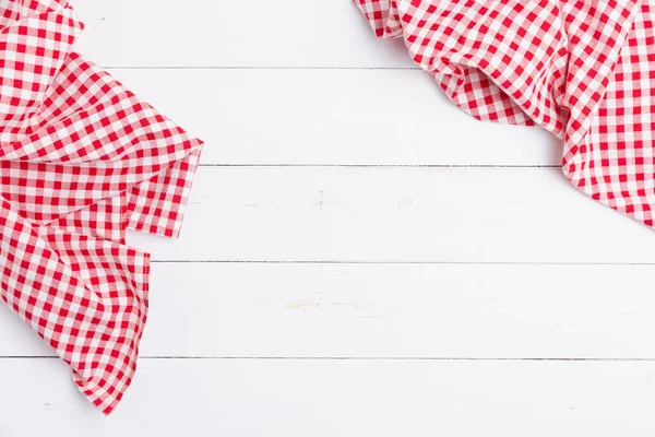 Flat lay cotton with copy space for text menu to restaurants. Top view of fabric tablecloth red and white checkered on wooden white table.