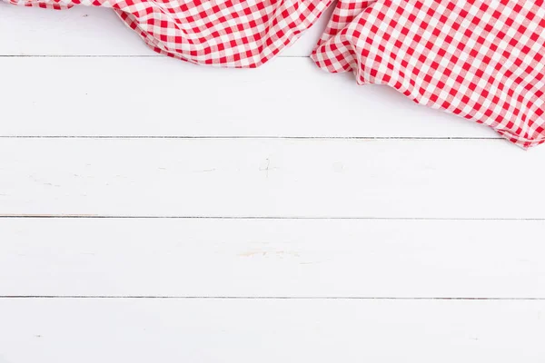 Top view of fabric tablecloth red and white checkered on wooden white table. Flat lay cotton with copy space for text menu to restaurants.