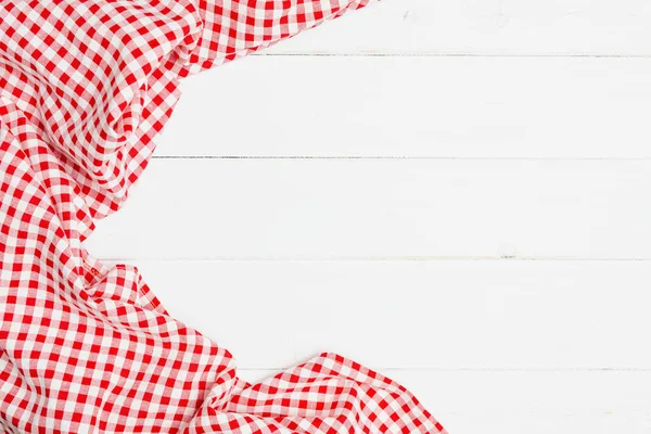 Crumpled clothes red and white on white background for a menu of a restaurant with copy space. Top view fabric tablecloth on old white wood background. Flat lay checked fabric old wooden.
