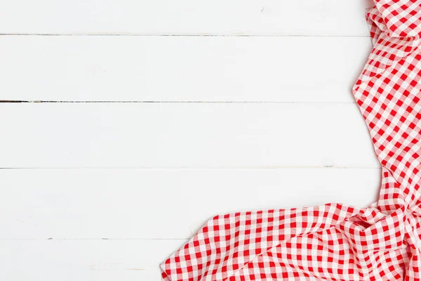 Red and white crumpled clothes on white background for a menu of a restaurant with copy space. Top view fabric tablecloth on old white wood background.