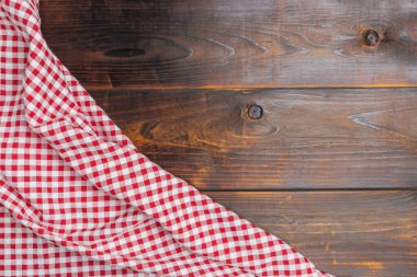 Fabric texture background. Texture of cotton fabric. Tablecloth red and white checkered squared on old wooden, top view. With copy space for design menu of food for restaurant.