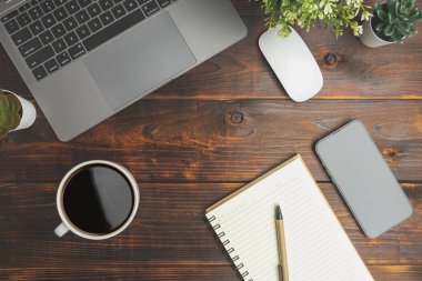Top view old wood desk office with laptop, notebook, coffee of cup and a pen on wood background. Business office for meeting concept