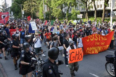 Toronto, Ontario, Kanada - 06 / 25 / 2010: Polis, G20 zirvesi öncesinde düzenlenen protestoda Üniversite Bulvarı boyunca yürüyen binlerce eylemciyi kontrol etmek için bisikletleri kullandı