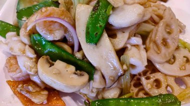 Lotus root stir fry with shrimp and mushroom.  Horizontal top view