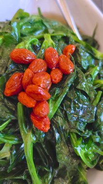 Steamed Chinese vegetable of pea shoots with red goji berry