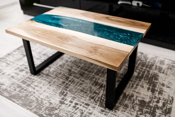 new wooden table with epoxy resin in the interior of the house