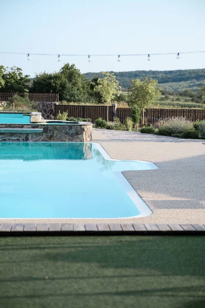 Large, clean, new swimming pool with warm water and seating area