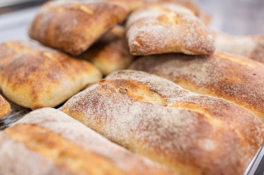 İnsanlar için taze pişmiş köy ekmeği. Kabuklu altın ekmek.